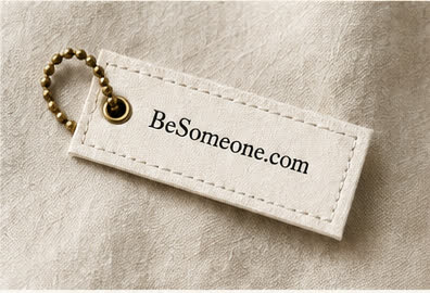 BeSomeone.com on a stitched cotton tag with brass hardware